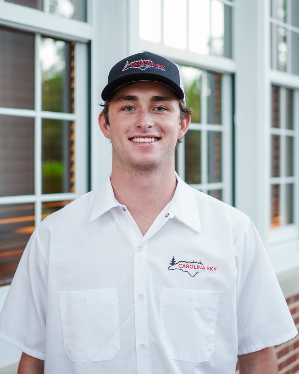 Will from Carolina Sky Holiday Lights wearing the company shirt and hat